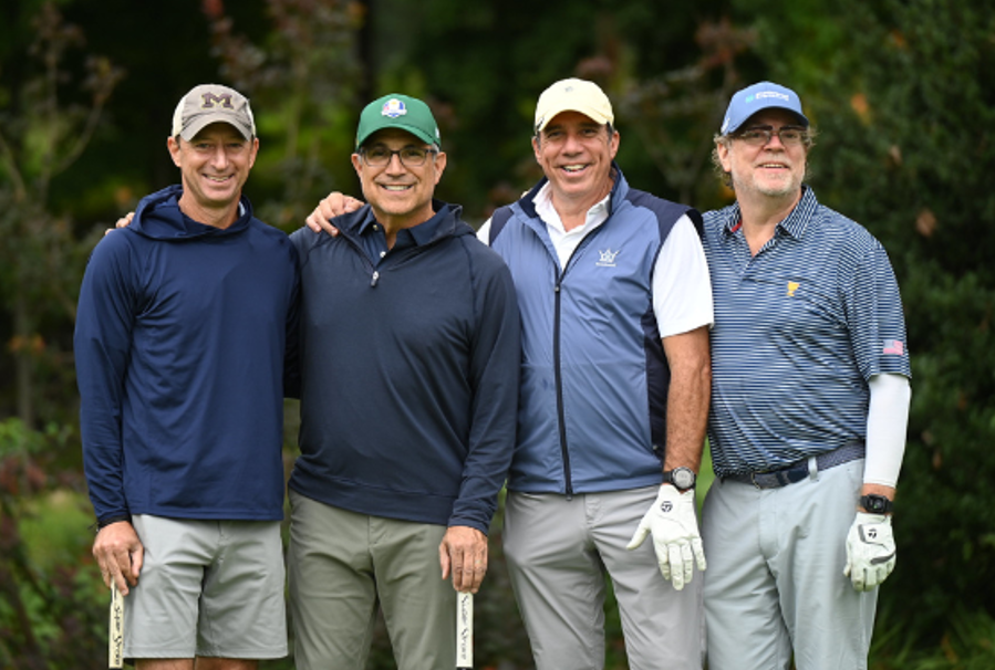 Men standing with golf clubs