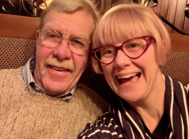 A selfie of the author and her father, smiling