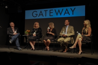 Three women and two men sit in directors' chairs on stage at the premiere of Gateway