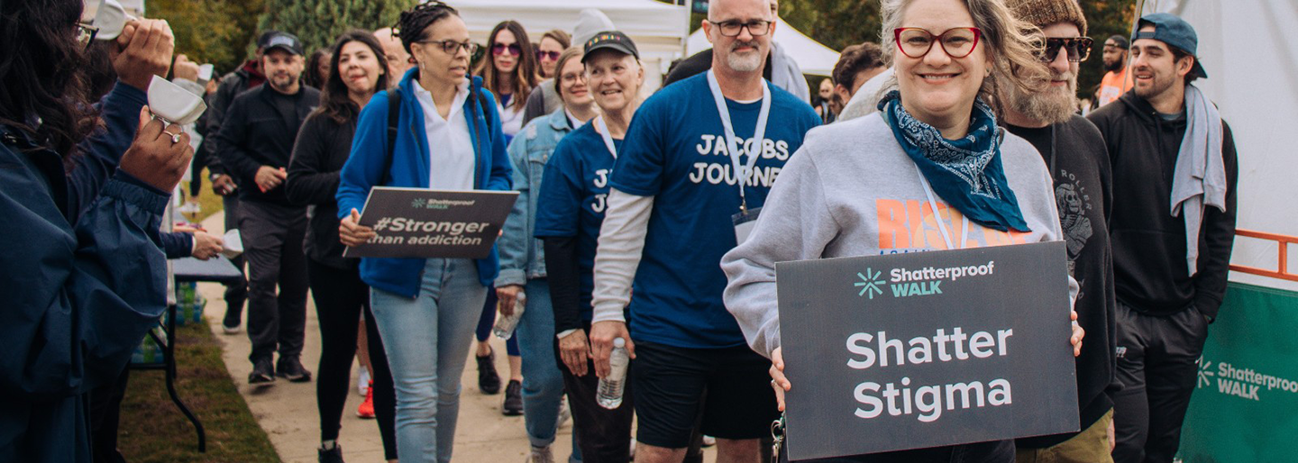 Woman holding up a shatter stigma sign