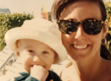 An old family photo of the author, in sunglasses, holding her baby son Tommy