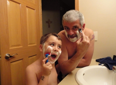 The author's father and son in the bathroom, shaving