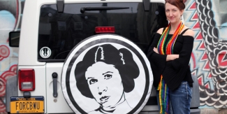 The author in front of her car, which features a Princess Leia tire cover