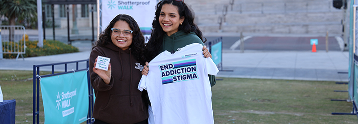 Two women with an end addiction stigma shirt